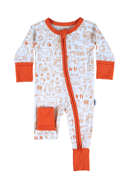 Our one-piece Barnyard Buddies zipper jammies are a charming farm-inspired design featuring a variety of animals including cows, chickens, horses, dogs, cats and more across a white background with matching orange cuffs and trim.